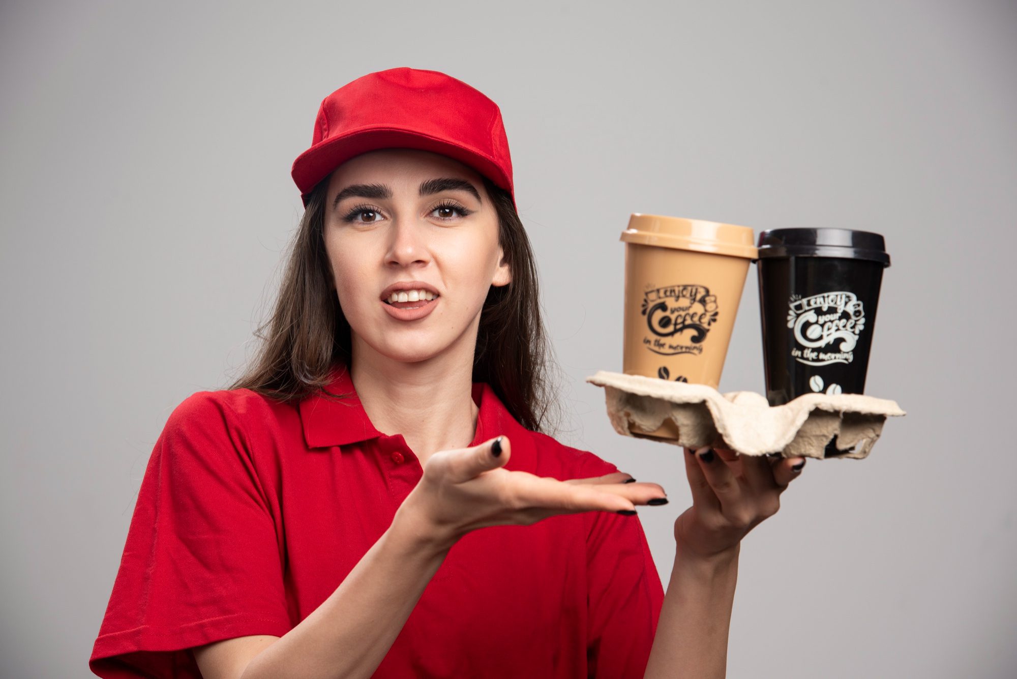 Delivery worker holding two takeaway coffee cups
